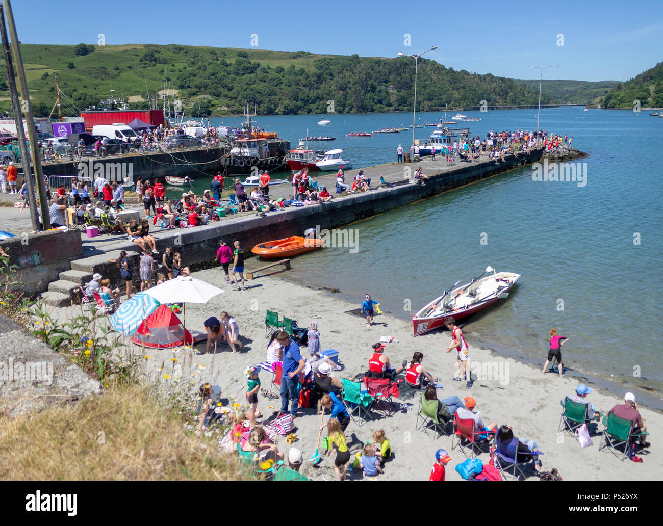 Union Hall, West Cork, Ireland. 24th June, 2018. The Union Hall Rowing Regatta took place today under a clear blue sky and blazing sunshine. The teams come from all over West Cork and the ideal weather conditions made for a great day out by the sea for spectators and crews alike: aphperspective/Alamy Live News Stock Photo