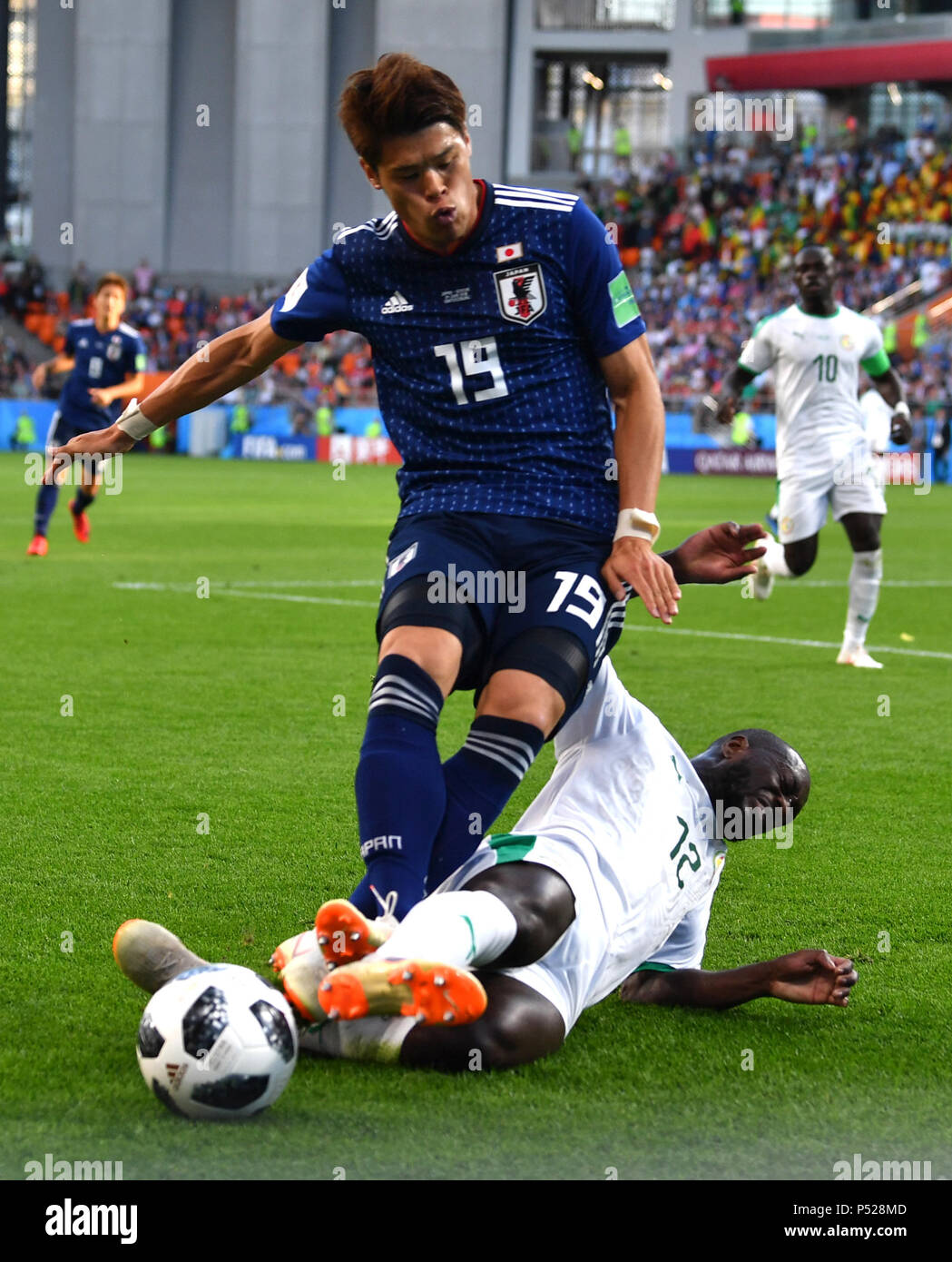 Yekaterinburg, Russia. 24th June, 2018. Hiroki Sakai (top) of Japan vies with Youssouf Sabaly of Senegal during the 2018 FIFA World Cup Group H match between Japan and Senegal in Yekaterinburg, Russia, June 24, 2018. Credit: Chen Cheng/Xinhua/Alamy Live News Stock Photo