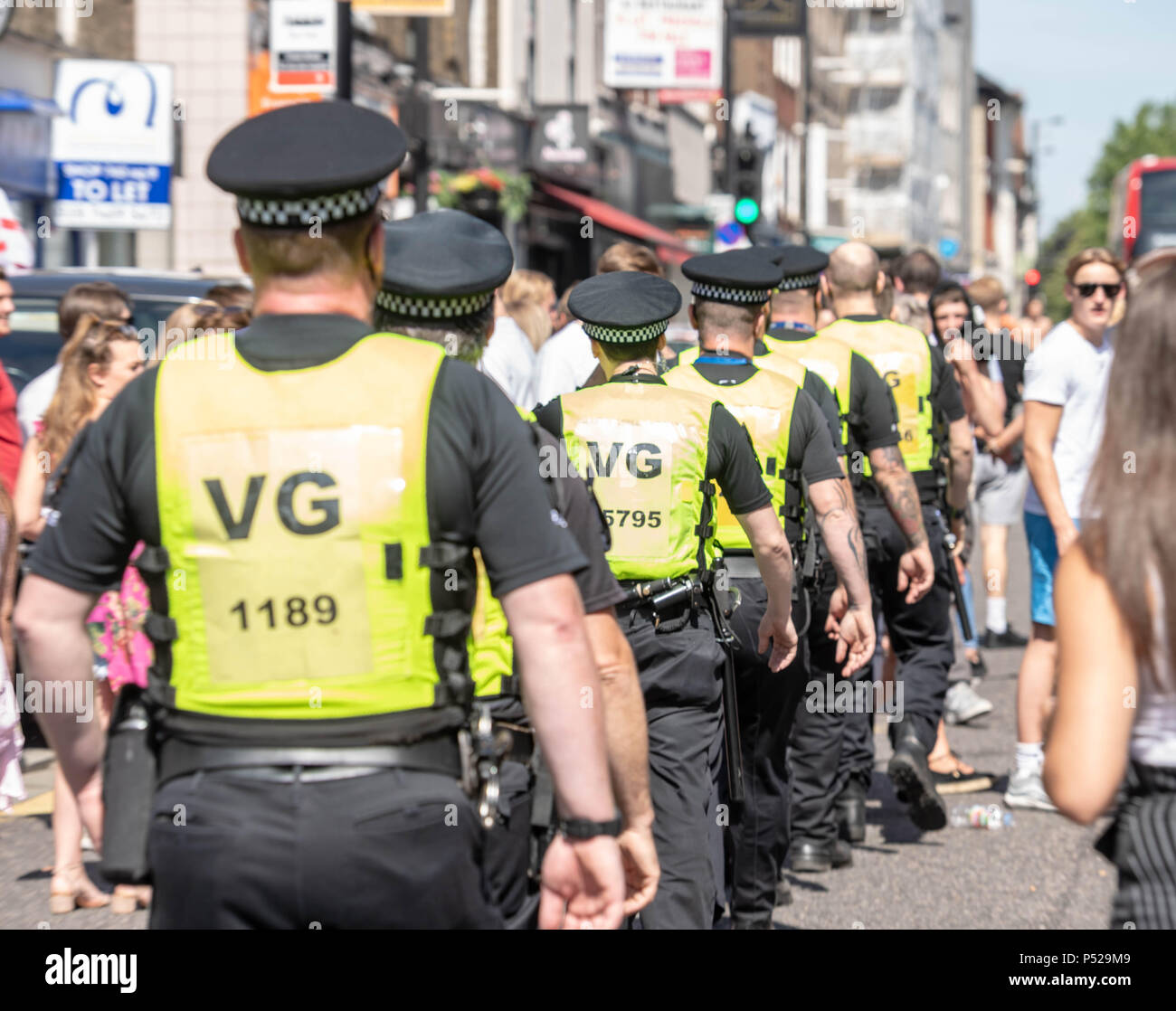 Brentwood, UK. 24 June 2018.  Large scale disorder in Brentwood High Street following England win in World Cup game.  Police required reinforcements, had their hats stolen and when a girl was detained for taking a hat the crowd threw cups and bottles at the police line.  Credit Ian Davidson/Alamy Live News Stock Photo