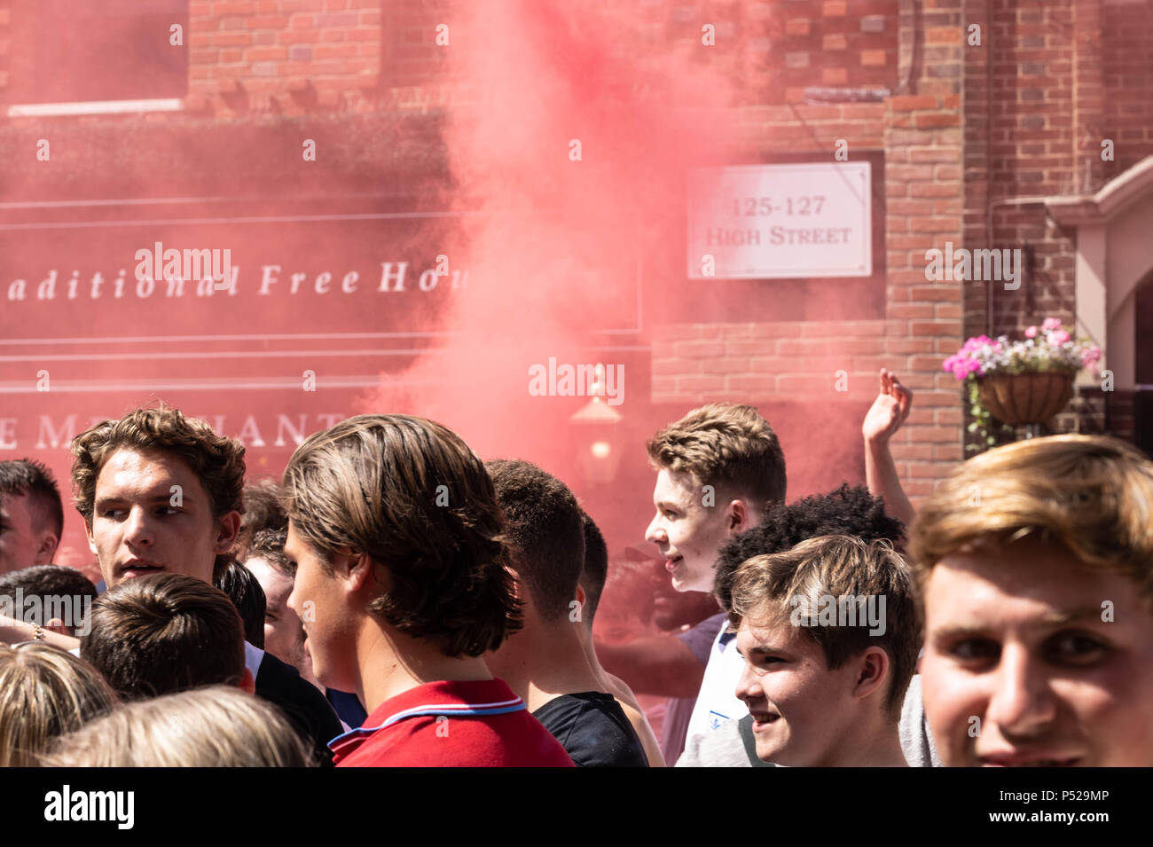 Brentwood, UK. 24 June 2018.  Large scale disorder in Brentwood High Street following England win in World Cup game.  Police required reinforcements, had their hats stolen and when a girl was detained for taking a hat the crowd threw cups and bottles at the police line.  Credit Ian Davidson/Alamy Live News Stock Photo