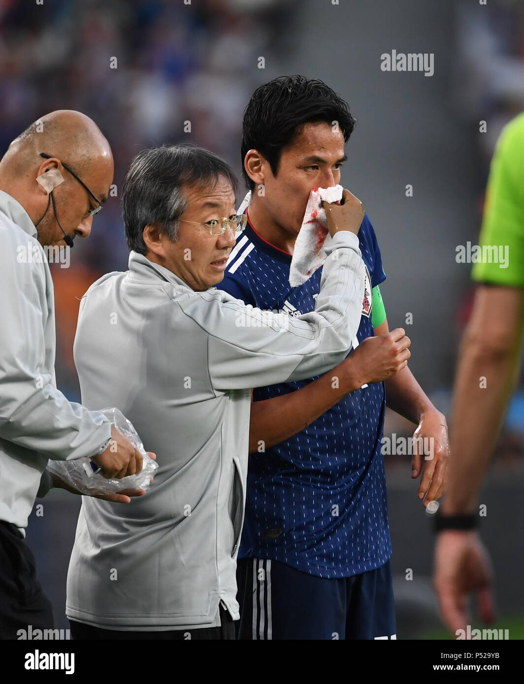 Yekaterinburg, Russia. 24th June, 2018. Makoto Hasebe (R) of Japan receives medical treatment during the 2018 FIFA World Cup Group H match between Japan and Senegal in Yekaterinburg, Russia, June 24, 2018. Credit: Chen Cheng/Xinhua/Alamy Live News Stock Photo