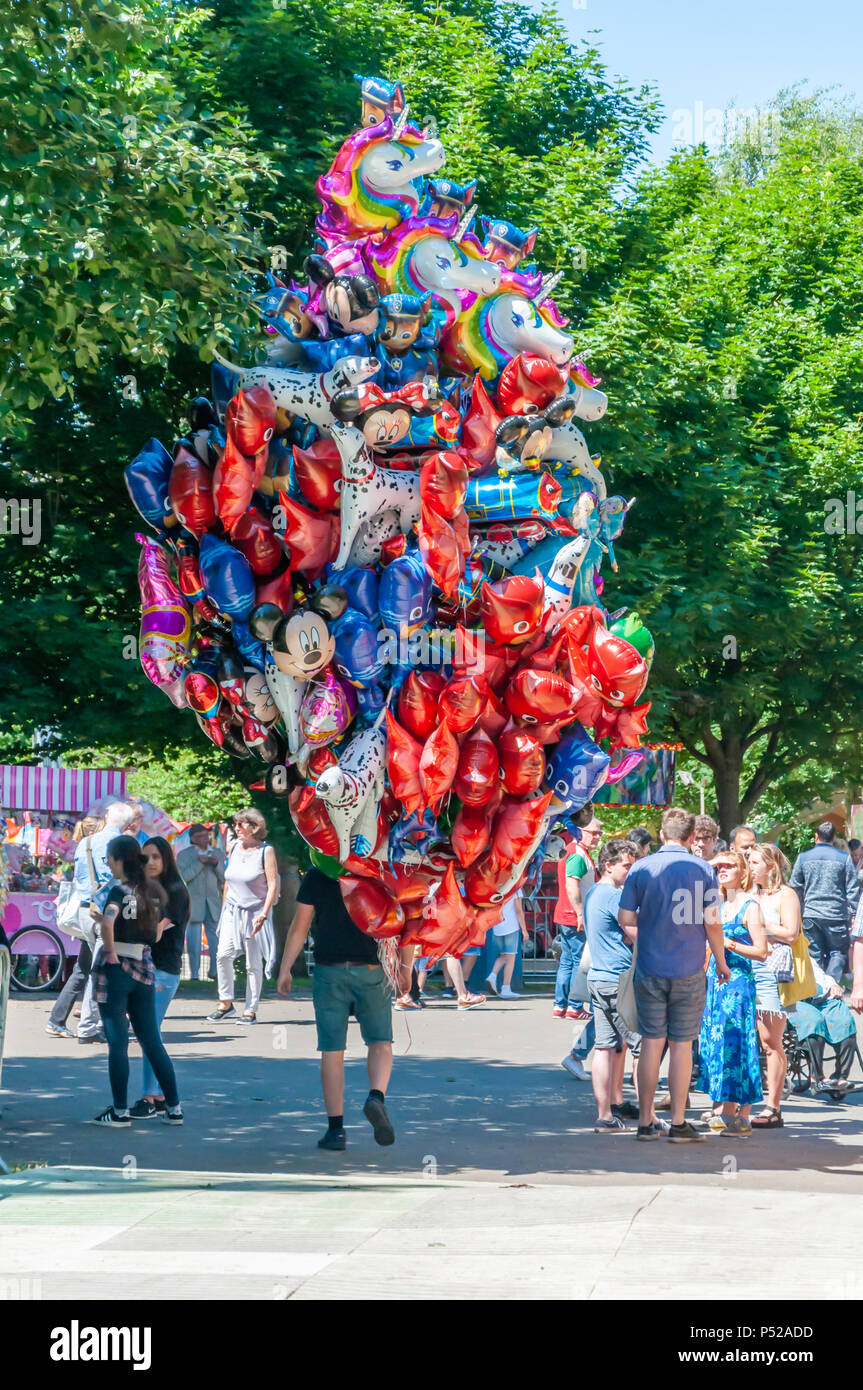 Glasgow, Scotland, UK. 24th June, 2018. A helium balloon seller at