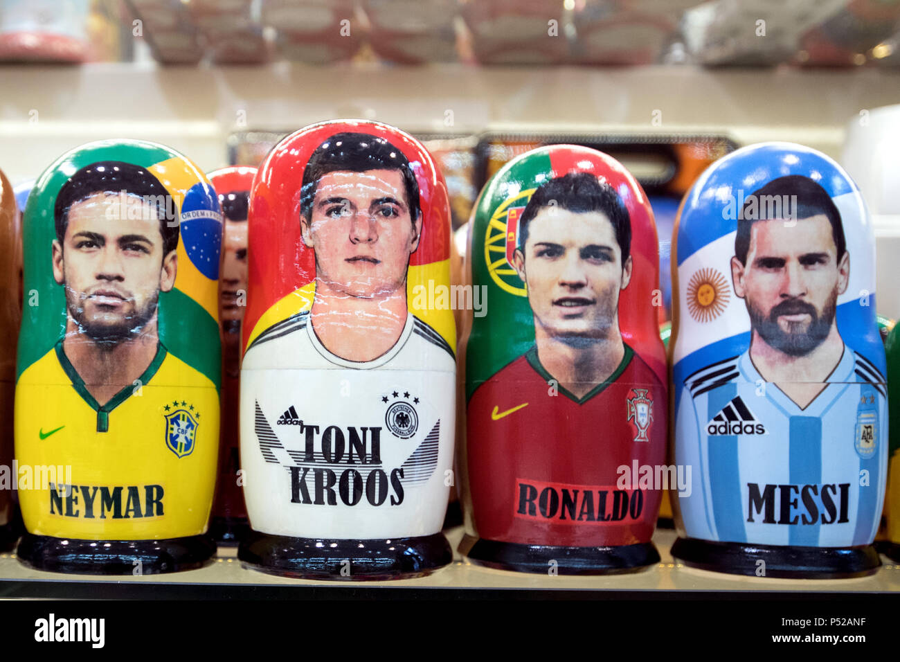 Moscow, Russia. 24th June, 2018. Matryoshka puppets of world cup stars Neymar (L-R) from Brazil, Germany's Toni Kroos, Portugal's Cristiano Ronaldo and Argentina's Lionel Messi standing on a shelf in a souvenir shop. Credit: Federico Gambarini/dpa/Alamy Live News Stock Photo