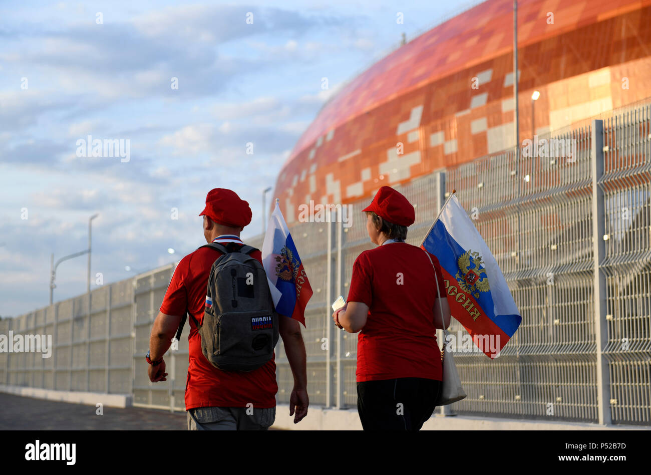 Saransk, Russia. 24th June, 2018. Soccer, World Cup 2018. Two Russian fans walking past the Mordovia arena. Credit: Andreas Gebert/dpa/Alamy Live News Stock Photo