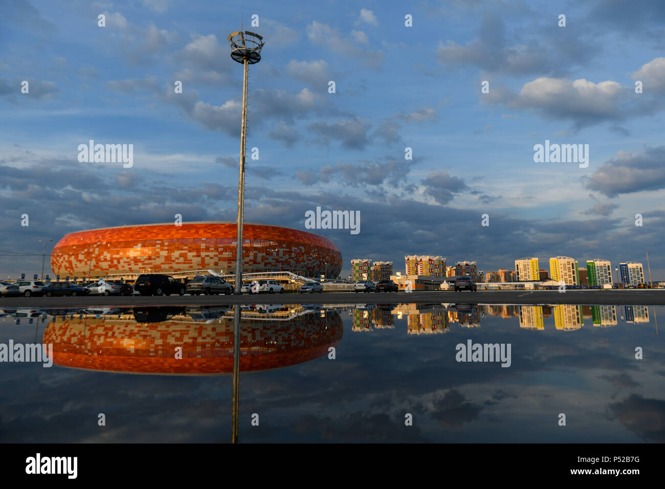 Saransk, Russia. 24th June, 2018. Soccer, World Cup 2018. The Mordovia arena reflected in a puddle at a car park in front of the stadium. Credit: Andreas Gebert/dpa/Alamy Live News Stock Photo