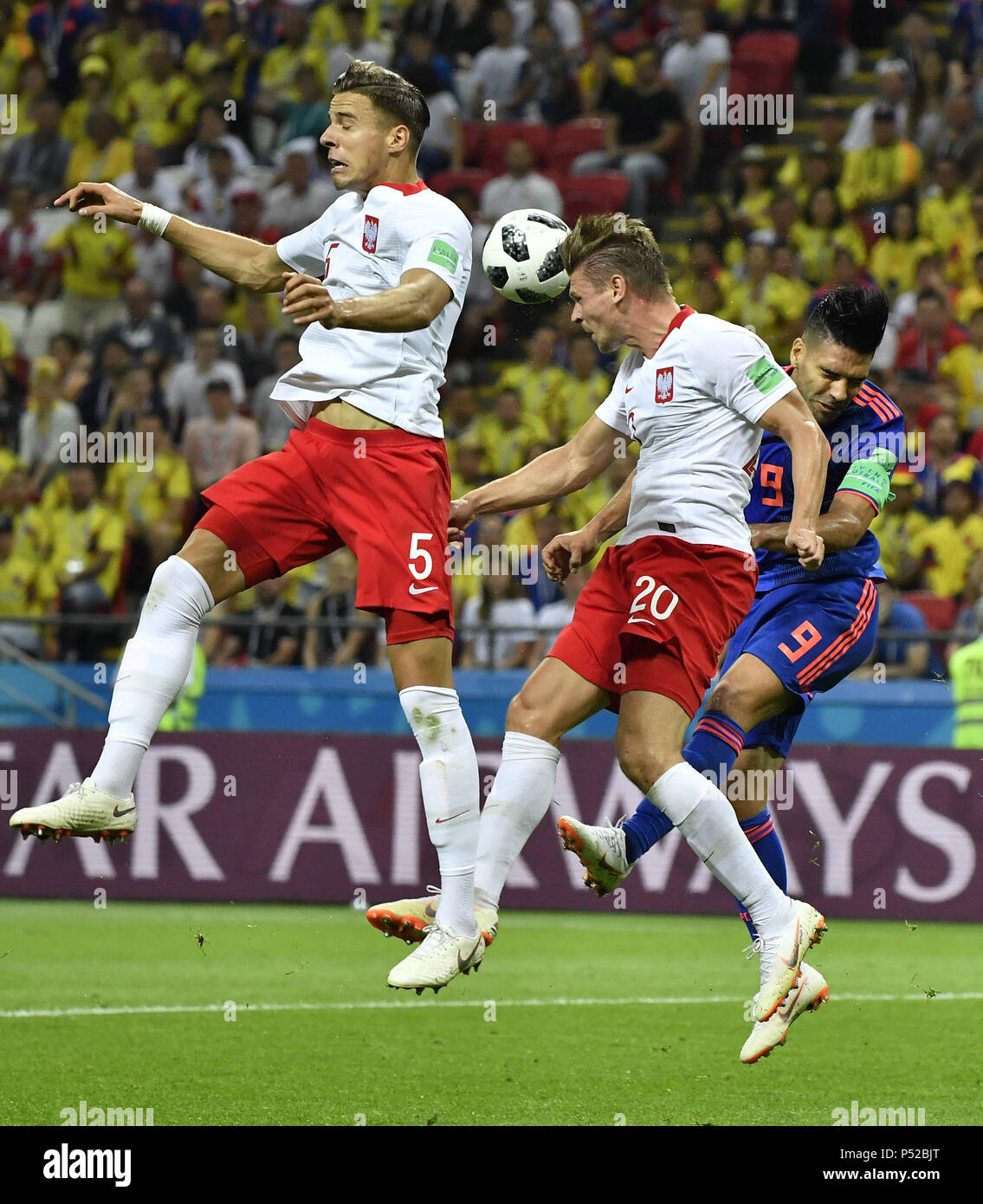 Kazan, Russia. 24th June, 2018. Radamel Falcao (R) of Colombia competes for a header with Lukasz Piszcek (C) and Jan Bednarek of Poland during the 2018 FIFA World Cup Group H match between Poland and Colombia in Kazan, Russia, June 24, 2018. Credit: He Canling/Xinhua/Alamy Live News Stock Photo