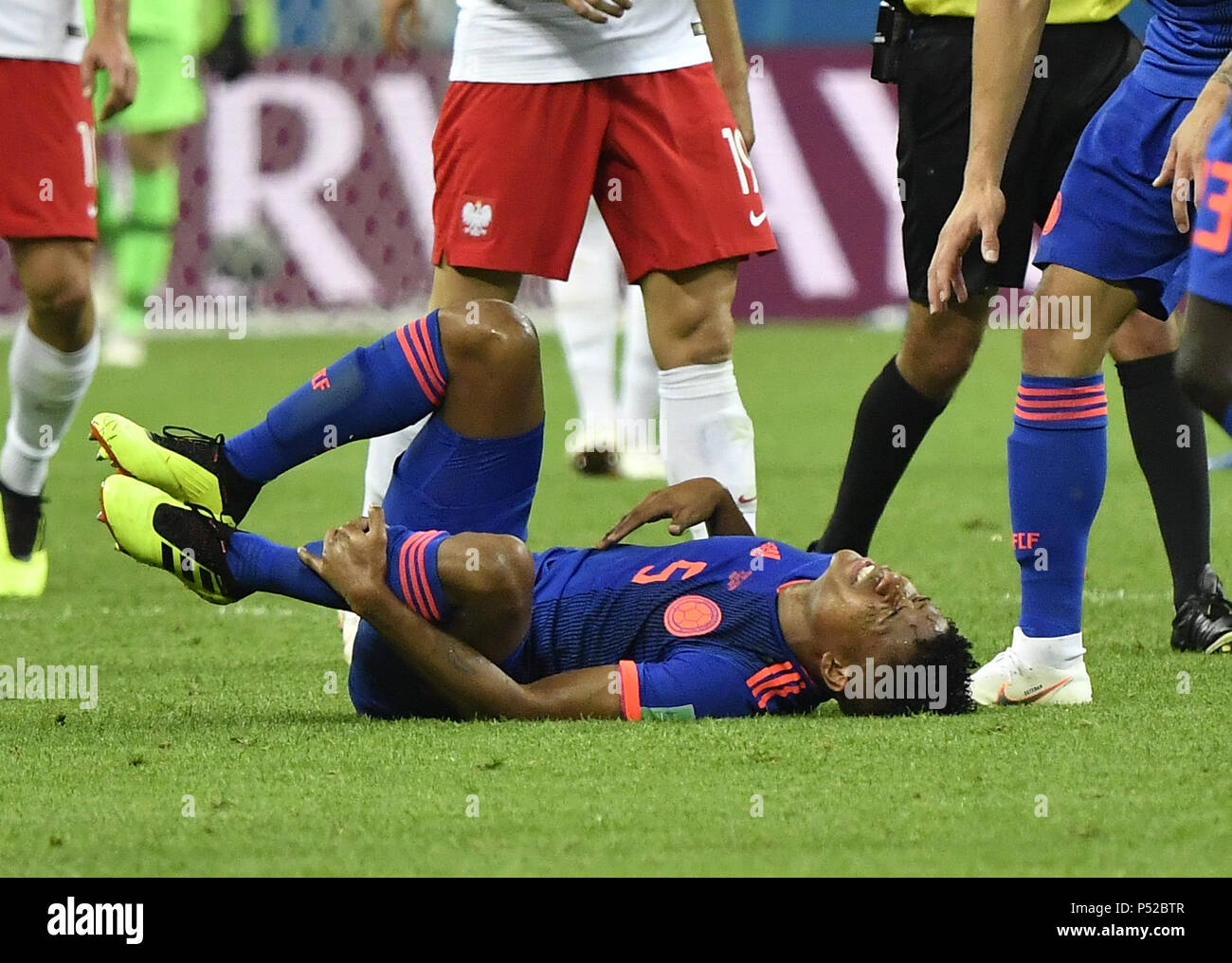 Kazan, Russia. 24th June, 2018. Wilmar Barrios (bottom) of Colombia sustains injury during the 2018 FIFA World Cup Group H match between Poland and Colombia in Kazan, Russia, June 24, 2018. Credit: He Canling/Xinhua/Alamy Live News Stock Photo
