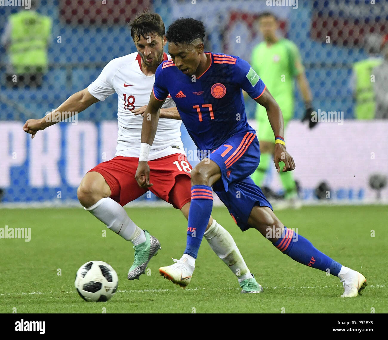 Kazan, Russia. 24th June, 2018. Bartosz Bereszynski (L) of Poland vies with Johan Mojica of Colombia during the 2018 FIFA World Cup Group H match between Poland and Colombia in Kazan, Russia, June 24, 2018. Credit: He Canling/Xinhua/Alamy Live News Stock Photo
