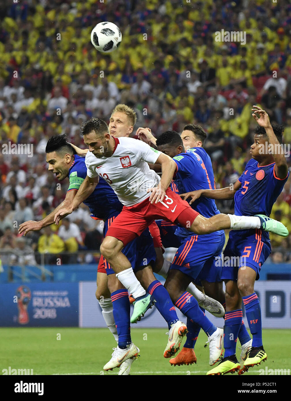 Kazan, Russia. 24th June, 2018. Maciej Rybus (2nd L) of Poland competes for a header during the 2018 FIFA World Cup Group H match between Poland and Colombia in Kazan, Russia, June 24, 2018. Colombia won 3-0. Credit: He Canling/Xinhua/Alamy Live News Stock Photo
