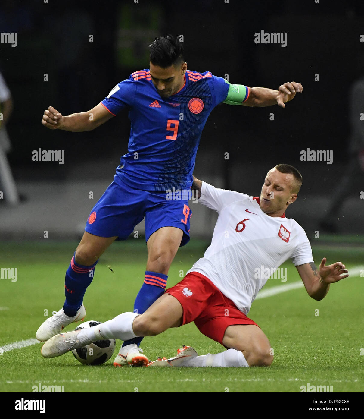 Kazan, Russia. 24th June, 2018. Jacek Goralski (R) of Poland vies with Radamel Falcao of Colombia during the 2018 FIFA World Cup Group H match between Poland and Colombia in Kazan, Russia, June 24, 2018. Colombia won 3-0. Credit: He Canling/Xinhua/Alamy Live News Stock Photo