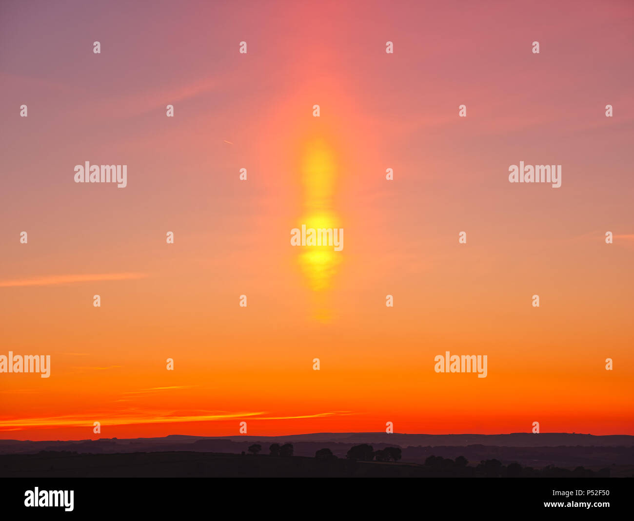 Brassington, Derbyshire, UK. 24th June, 2018. Weather UK: sun pillar solar column during an amazing sunset at Harborough Rocks near Brassington & the High Peak Trail, Derbyshire, Peak District National Park Credit: Doug Blane/Alamy Live News Stock Photo