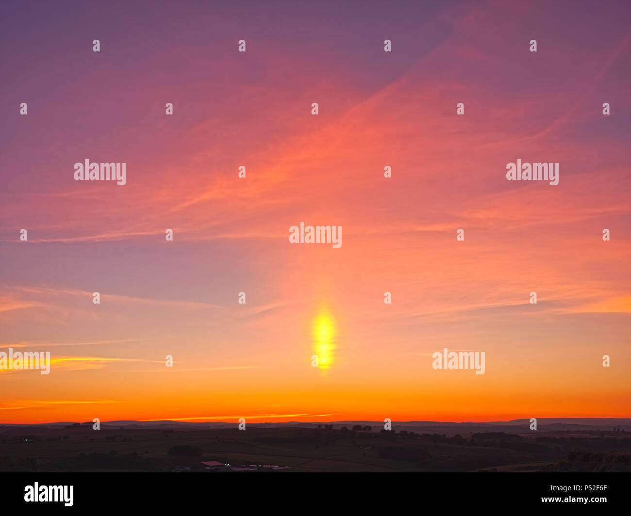 Brassington, Derbyshire, UK. 24th June, 2018. Weather UK: sun pillar solar column during an amazing sunset at Harborough Rocks near Brassington & the High Peak Trail, Derbyshire, Peak District National Park Credit: Doug Blane/Alamy Live News Stock Photo