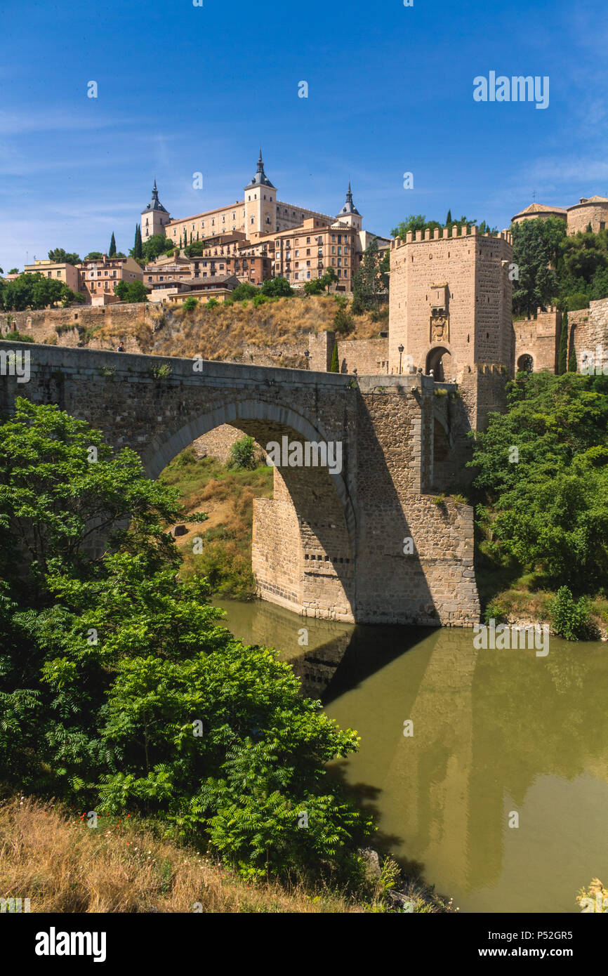 Roman bridge, Alcantara Bridge with Alcazar fortress, and Tagus River Toledo Spain Stock Photo