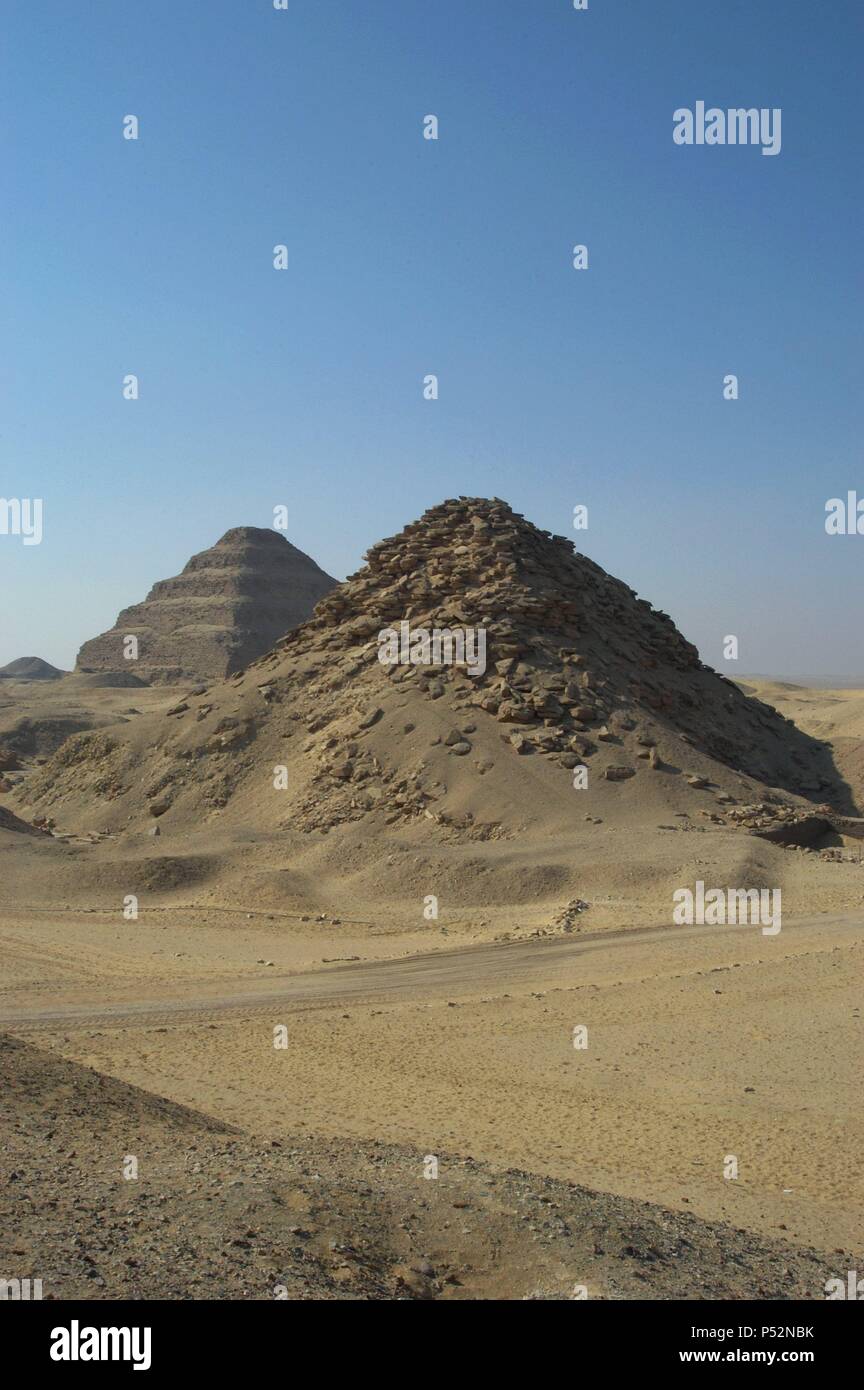 Pyramid of Userkaf. At background, Djoser Pyramid. Old kingdom. Saqqara. Egypt. Stock Photo