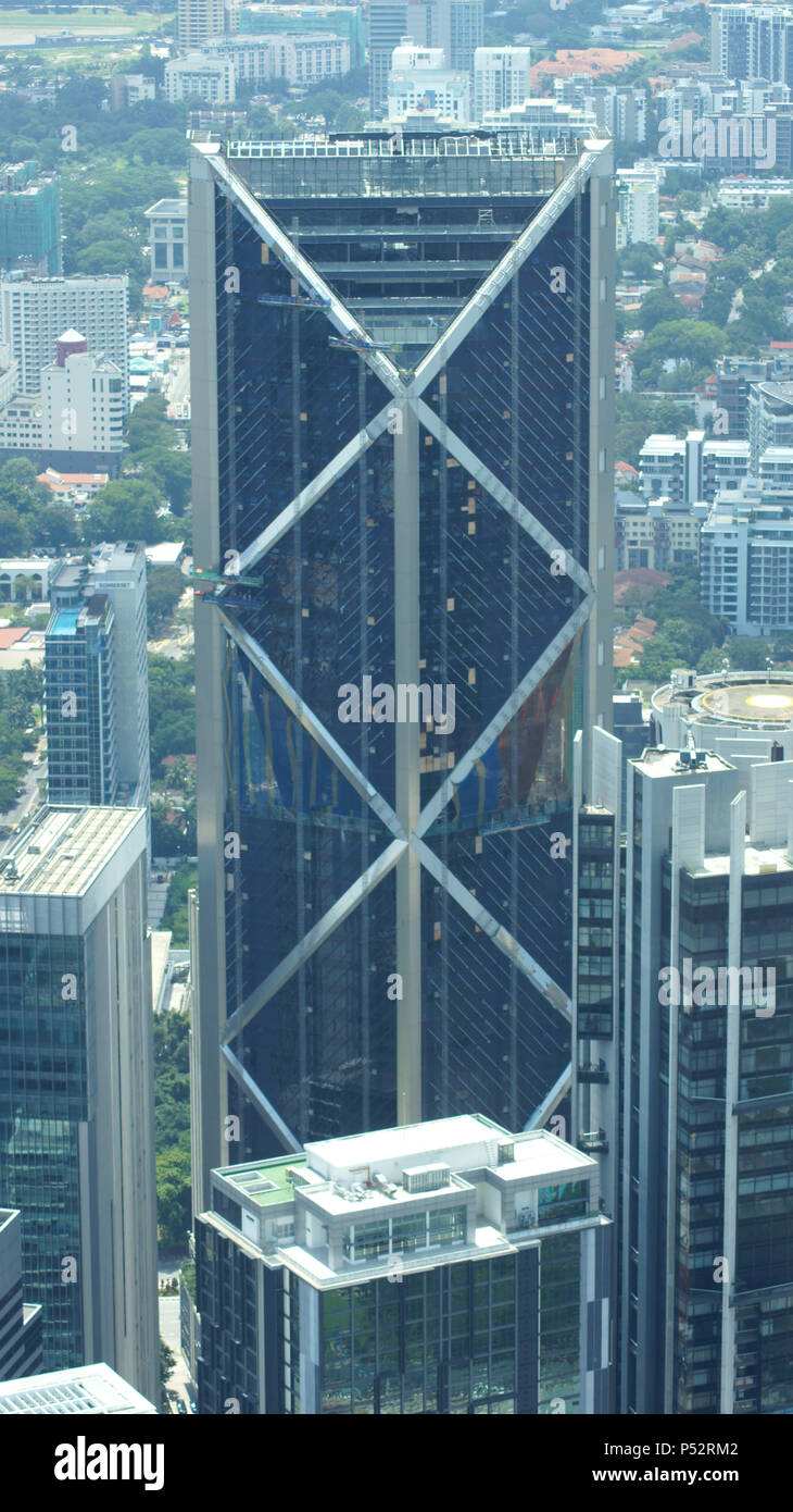 KUALA LUMPUR, MALAYSIA - APR 12th 2015: Amazing view from sky bridge glass panel located 170 meter above street level of Petronas Twin Towers, the famous landmark and highest twin towers in the world Stock Photo