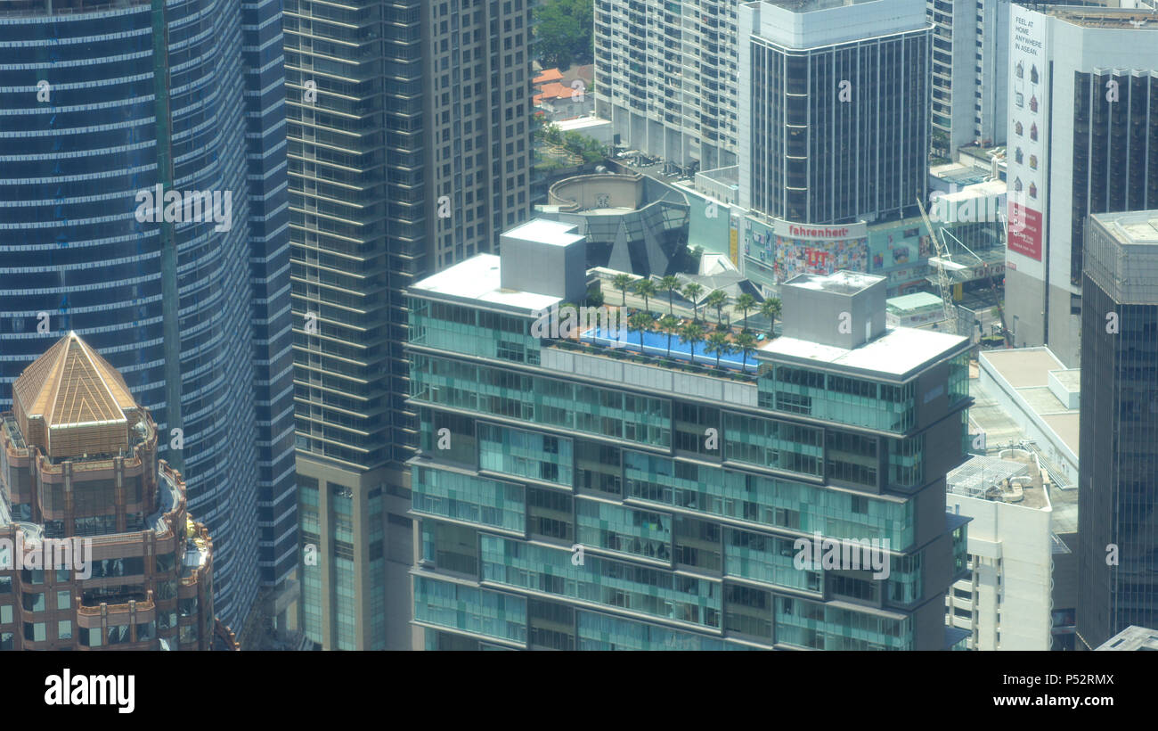 KUALA LUMPUR, MALAYSIA - APR 12th 2015: Amazing view from sky bridge glass panel located 170 meter above street level of Petronas Twin Towers, the famous landmark and highest twin towers in the world Stock Photo