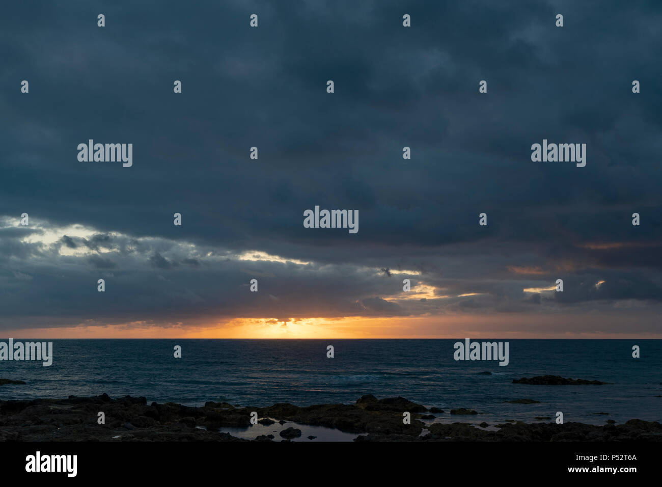 Punta del Hidalgo, Tenerife. Sun setting over Natural Pools in Punta del Hidalgo Stock Photo