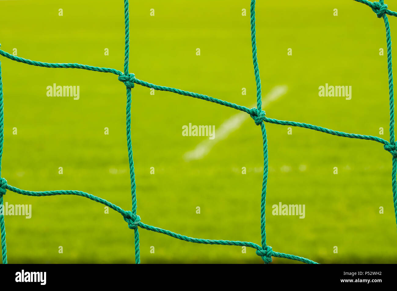 Soccer net on green grass close-up. Background Stock Photo