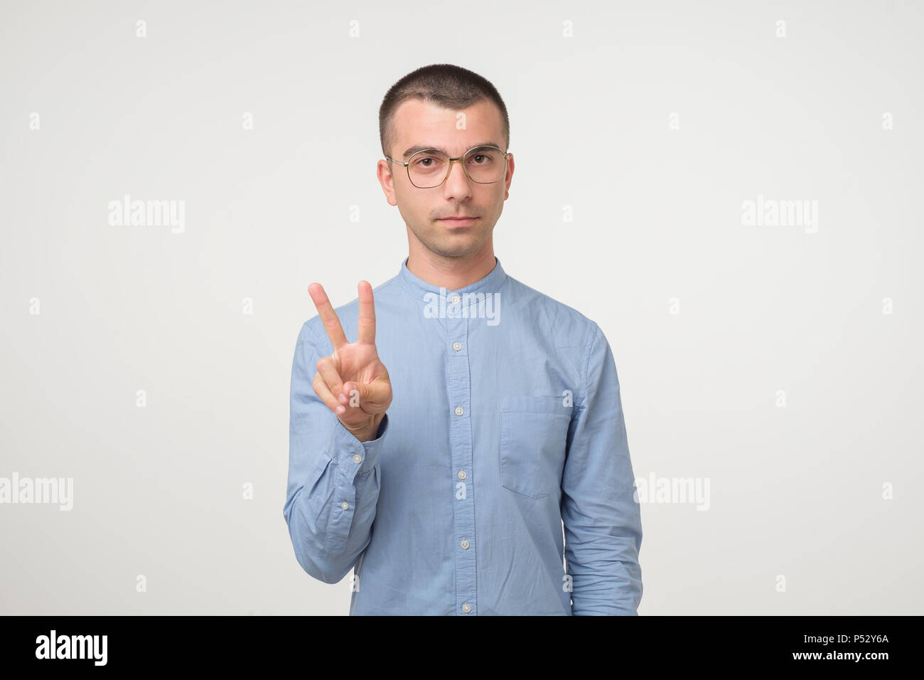 Man in blue shirt showing hi-res stock photography and images - Alamy