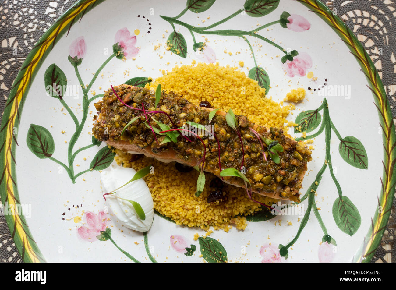 Grilled pistachio-crusted salmon and yellow rice Stock Photo
