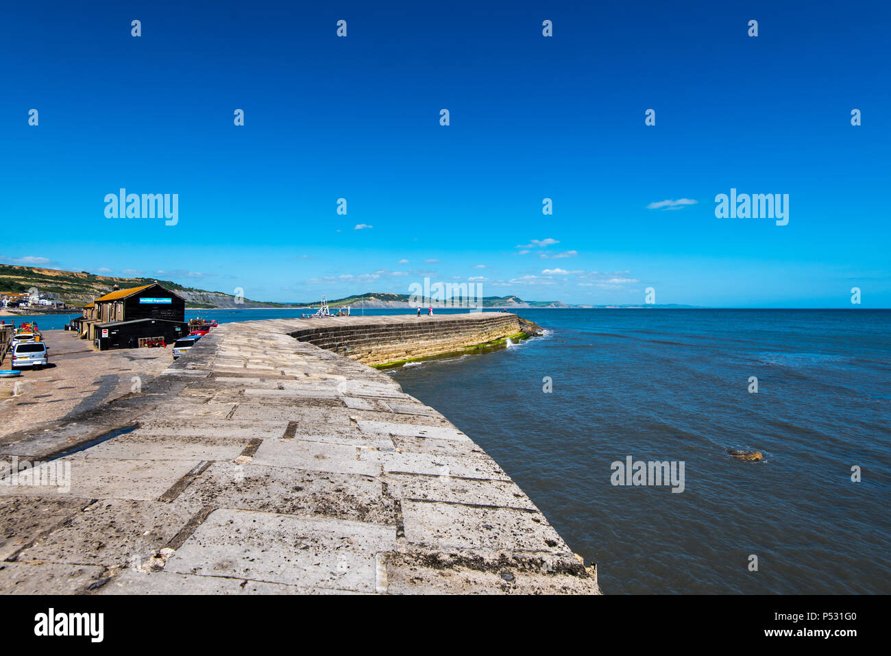LYME REGIS, DORSET, UK, 14JUN2018: The Cobb is an old stone pier which forms the harbour at Lyme Regis. Stock Photo