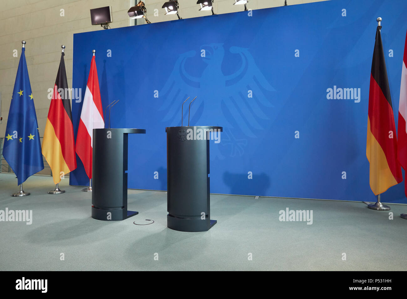 Berlin, Germany - logo wall, standing desks and the flags of Germany and Austria in the Chancellery Stock Photo