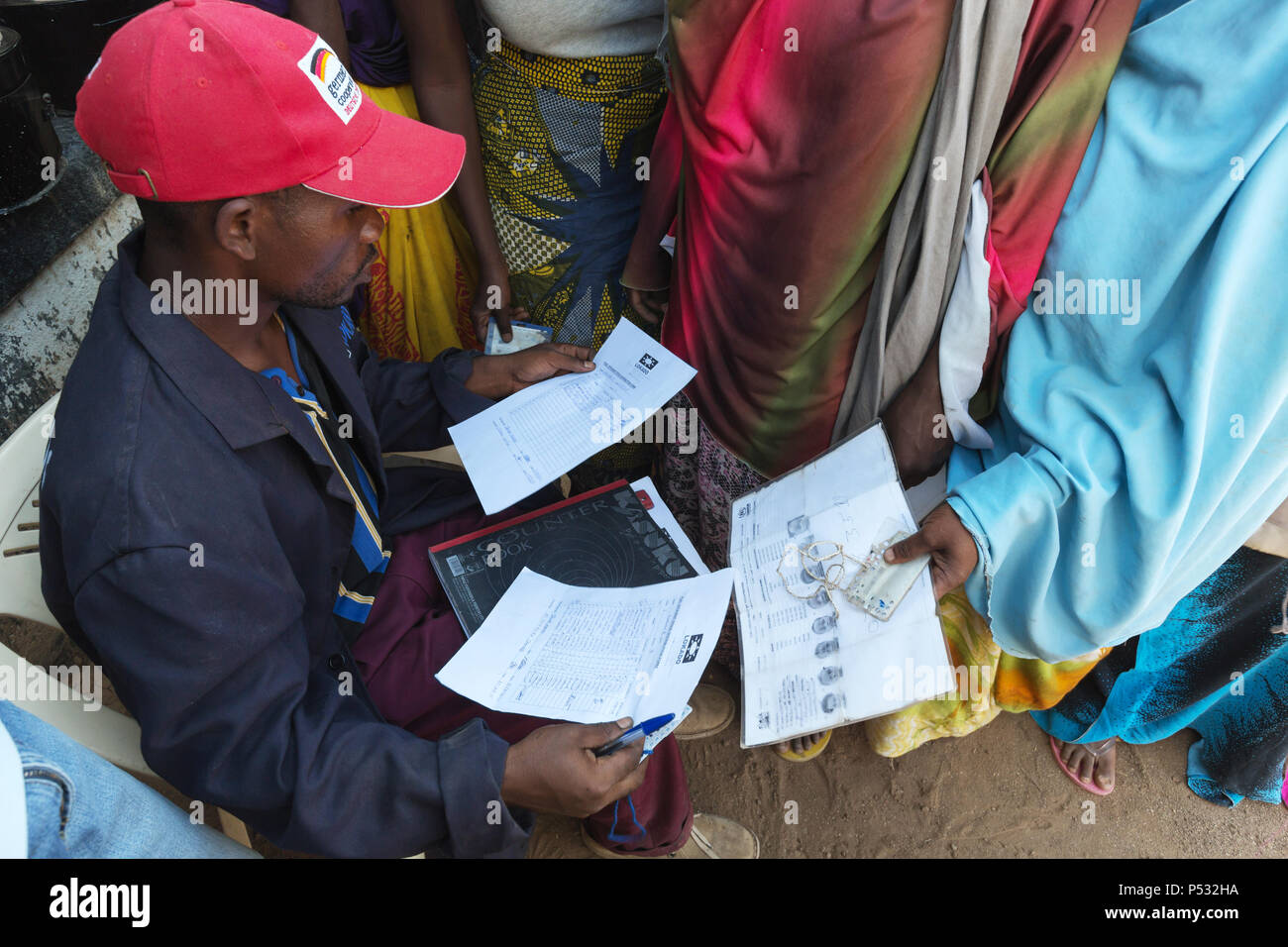 Kakuma, Kenya - An employee of the relief organization Lokado controls the Kakuma refugee camp with the help of a UNHCR refugee card. Stock Photo