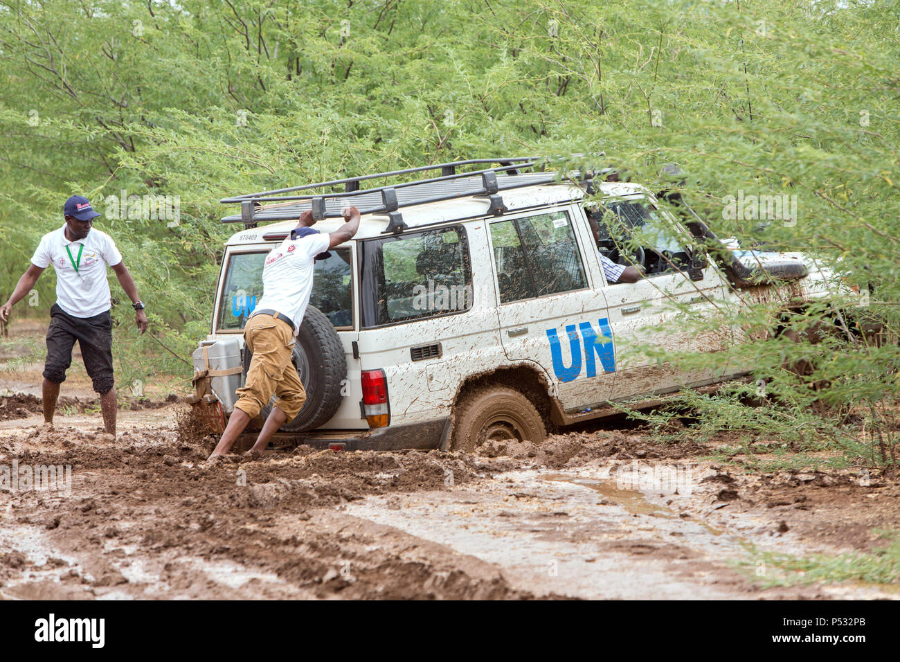 KAKUMA, KENYA - A UN Land Rover has got stuck on a dirt road deep in the mud. Stock Photo