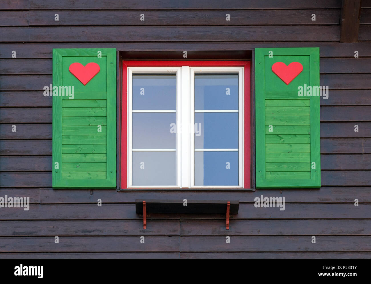 Heart symbols on the windows of a house Stock Photo
