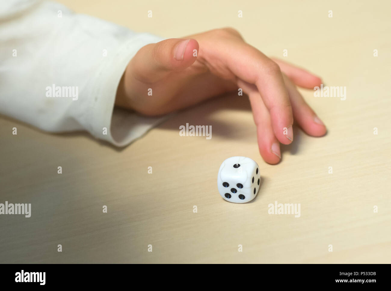 Children playing with a dice Stock Photo