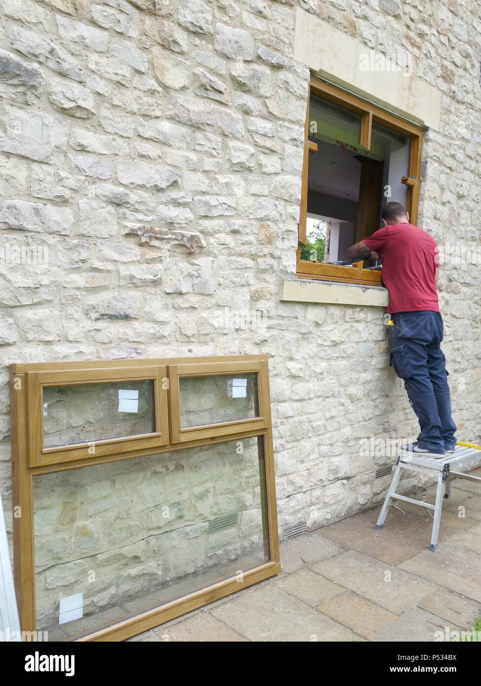 Window fitter replacing old double glazed uPVC window frames with new