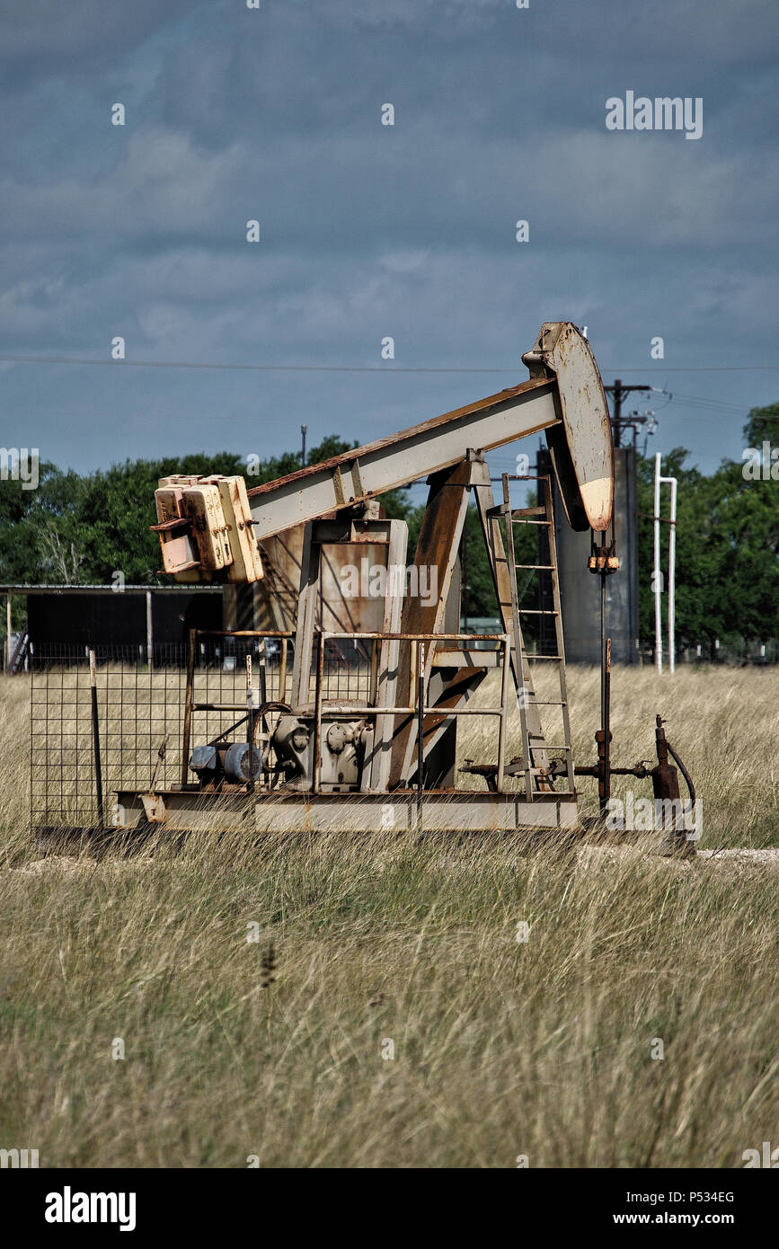 Oil well pump in a field in central Texas Stock Photo