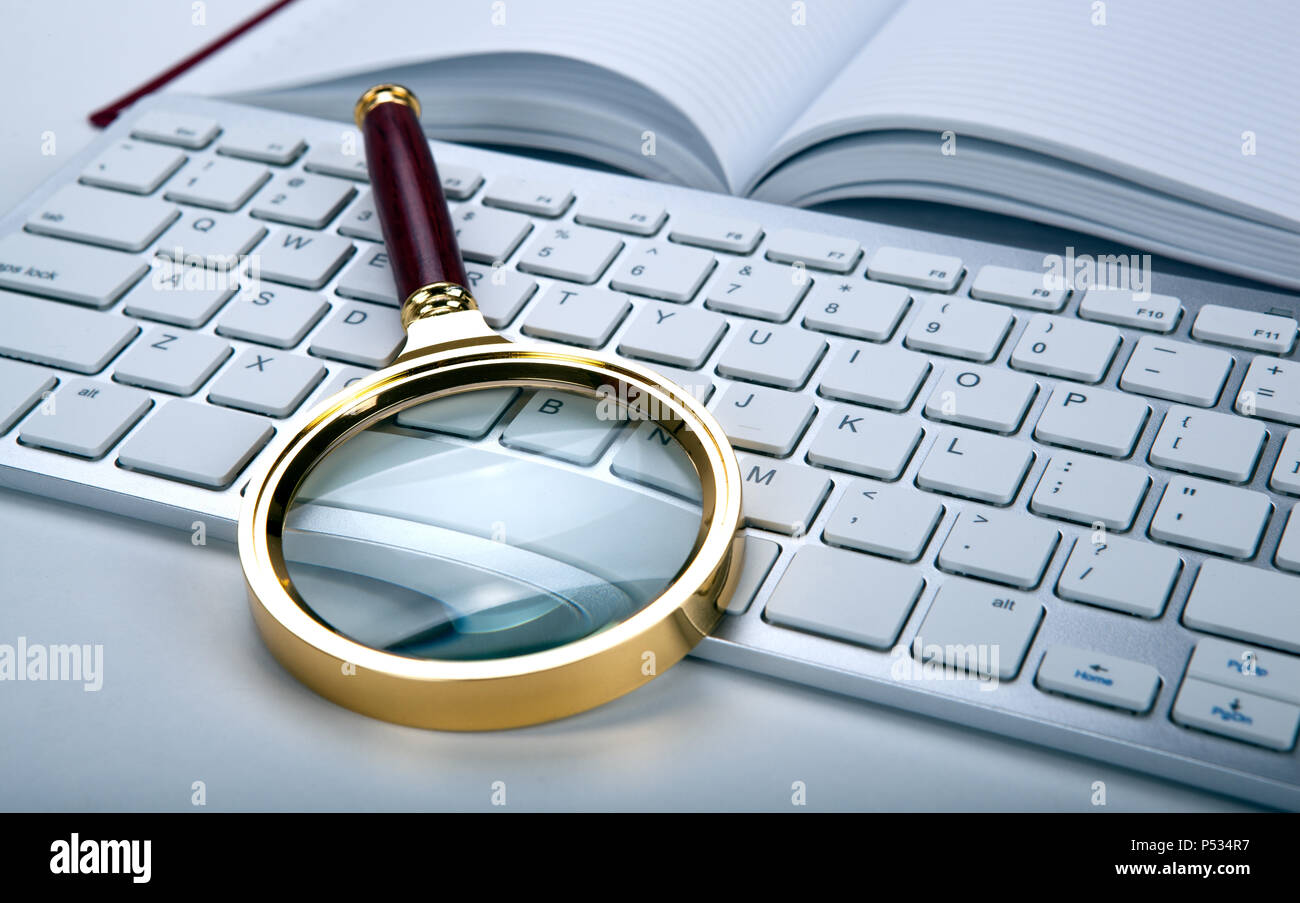 magnifier and computer keyboard on the desktop close up Stock Photo Alamy