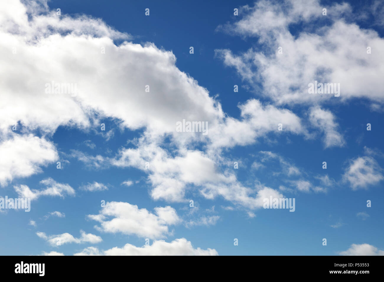 Fluffy white clouds in a blue sky Stock Photo - Alamy