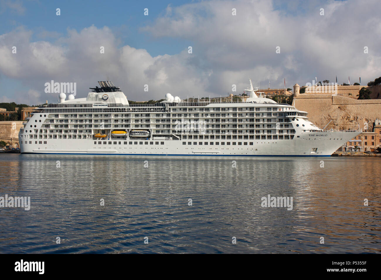 The residential cruise ship The World beneath the walls of Valletta in Malta's Grand Harbour Stock Photo