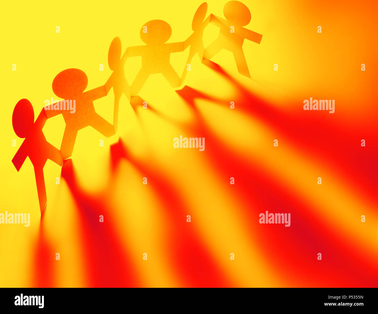 Team of paper chain people in a row holding hands Stock Photo - Alamy