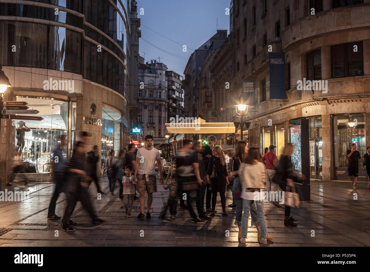 BELGRADE, SERBIA - APRIL 22, 2018: Kneza Mihailova street at night, crowded, with blurred people rushing. Also known as Knez Mihaila, this is the main Stock Photo