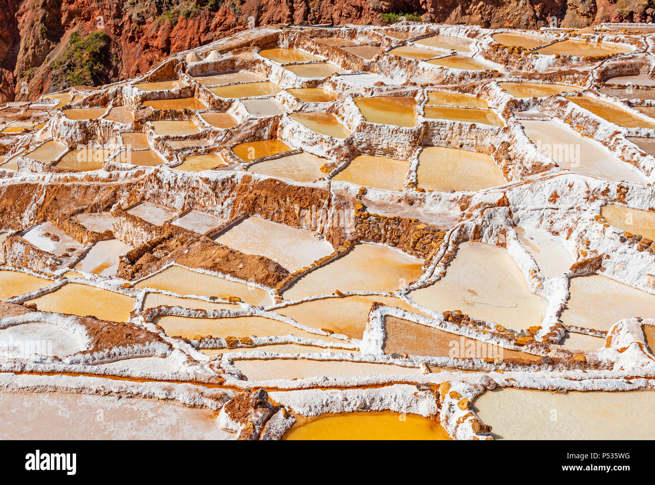 Close up of a famous landscape in the Cusco province: the Maras salt terraces that have been used since pre Inca times for salt winning, Peru. Stock Photo