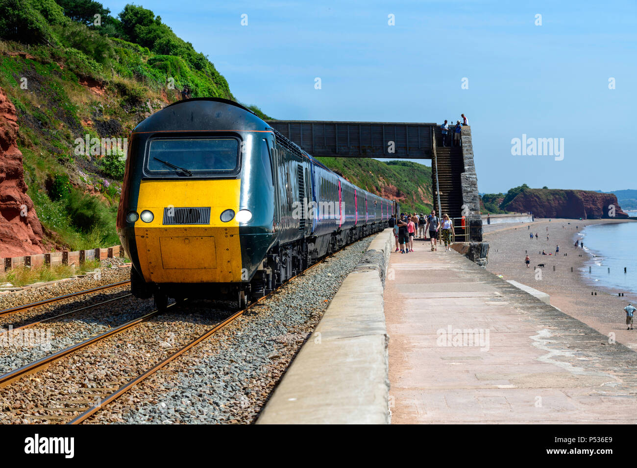 A High Speed Train (HST) speeds along by the sea wall Dawlish south Devon UK on a summers day. Stock Photo
