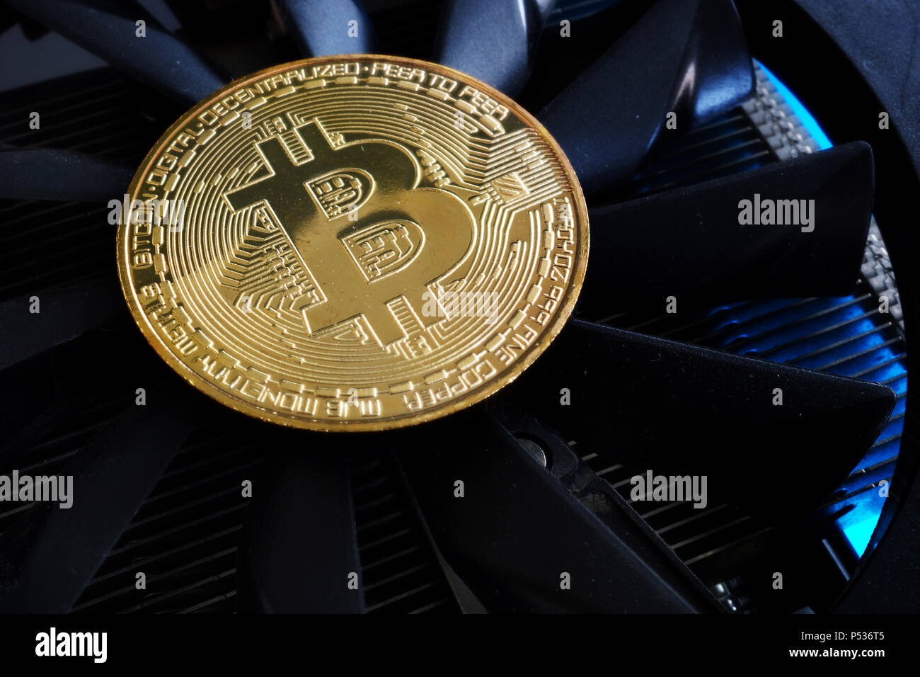 Cryptocurrency mining. Bitcoin BTC coin on a cooler. Stock Photo