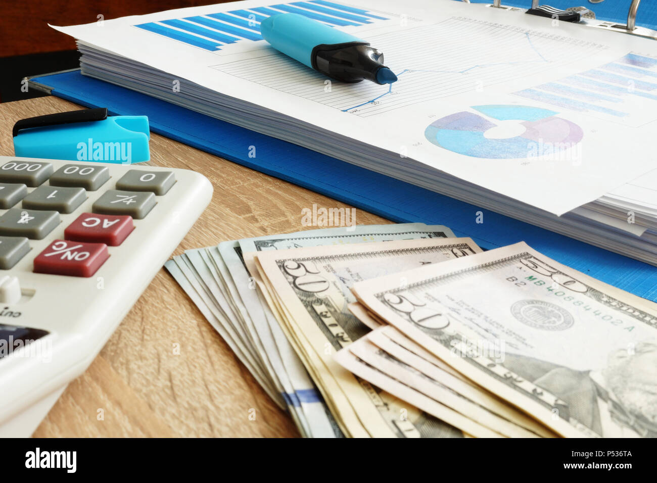 Small business accounting. Dollars, calculator and financial report. Stock Photo