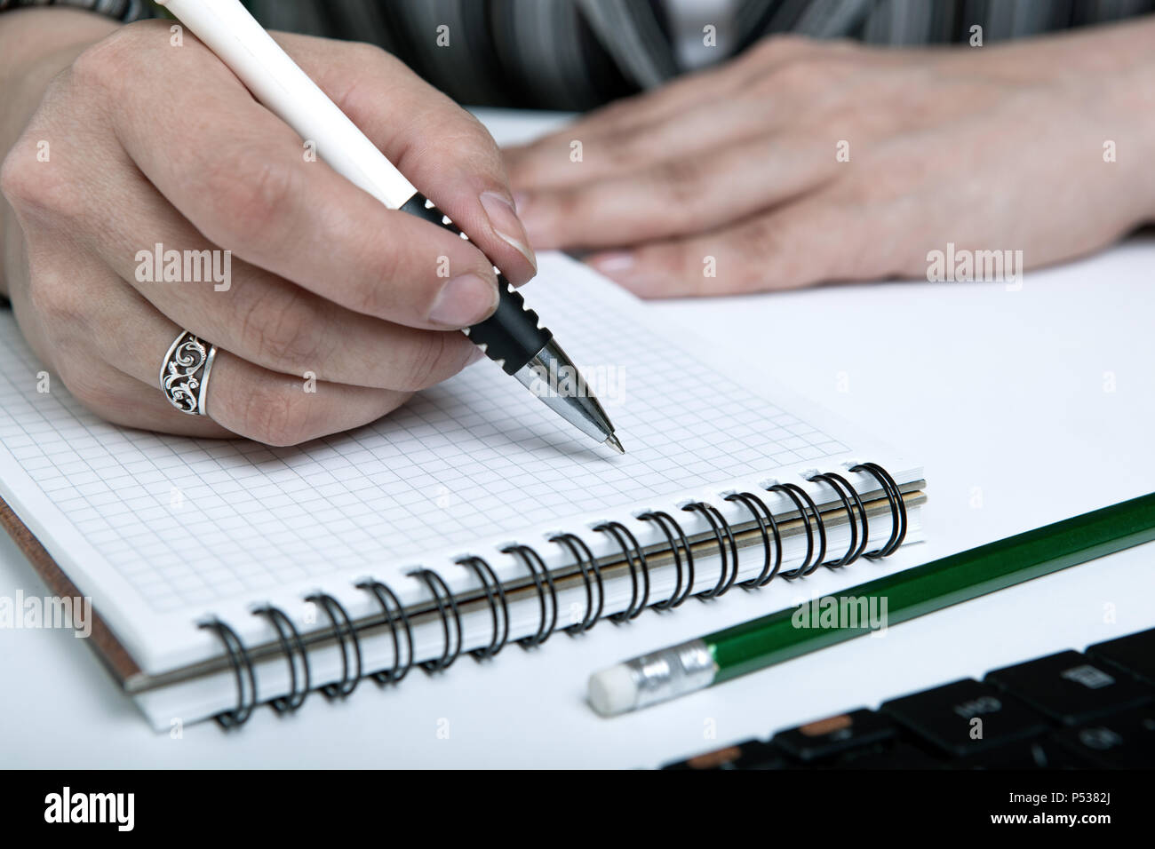 diary and human hand holding a pen close-up Stock Photo - Alamy