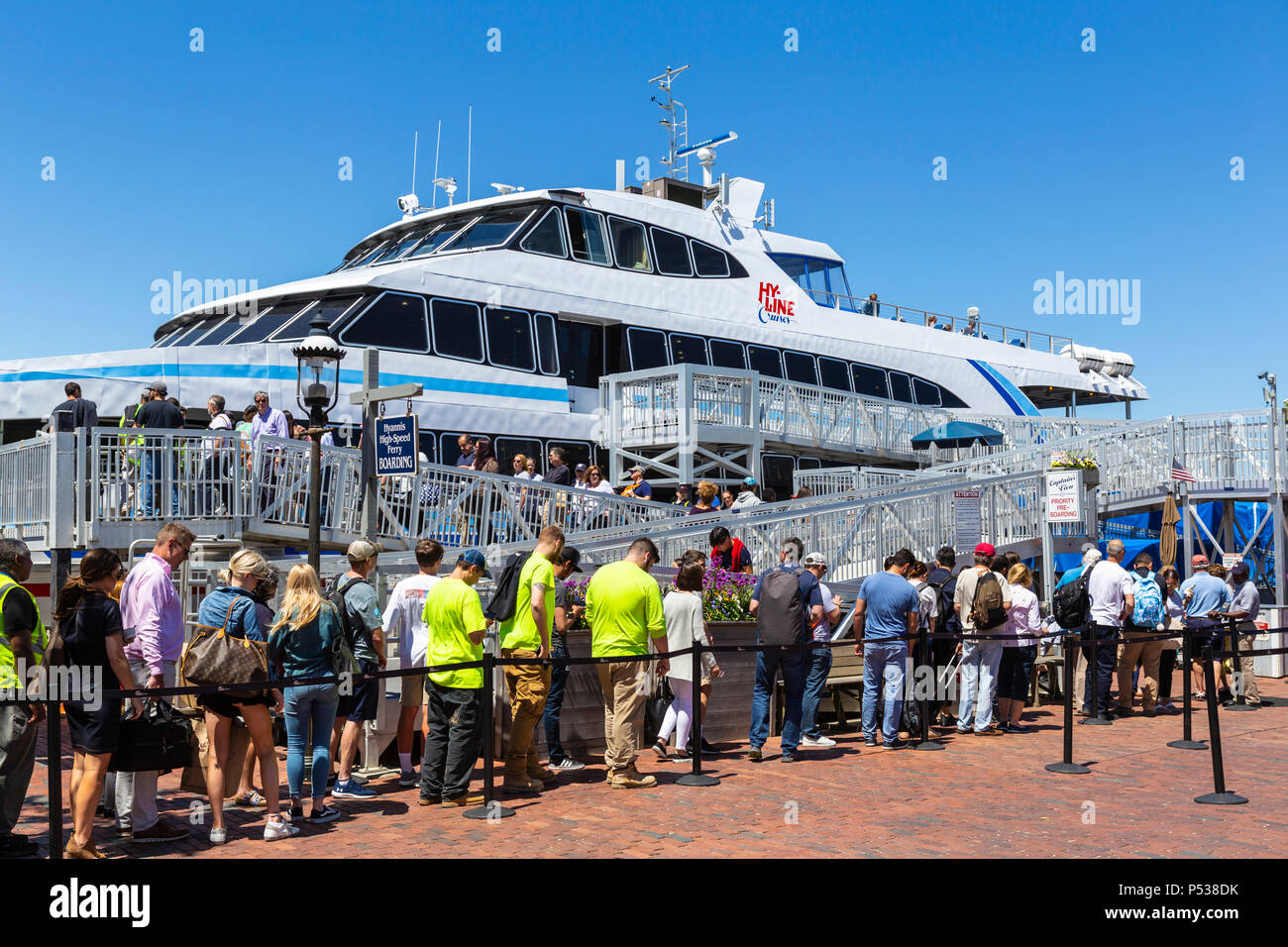 Passengers board a Hy-Line Cruises high-speed catamaran ferry, bound for Hyannis on the mainland, in Nantucket, Massachusetts. Stock Photo