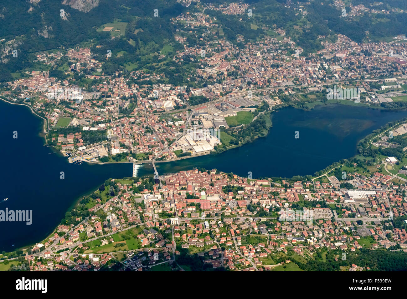 aerial shot, from a small plane, of villages on Adda river, shot on a bright late springtime day at Calolziocorte, Lombardy, Italy Stock Photo