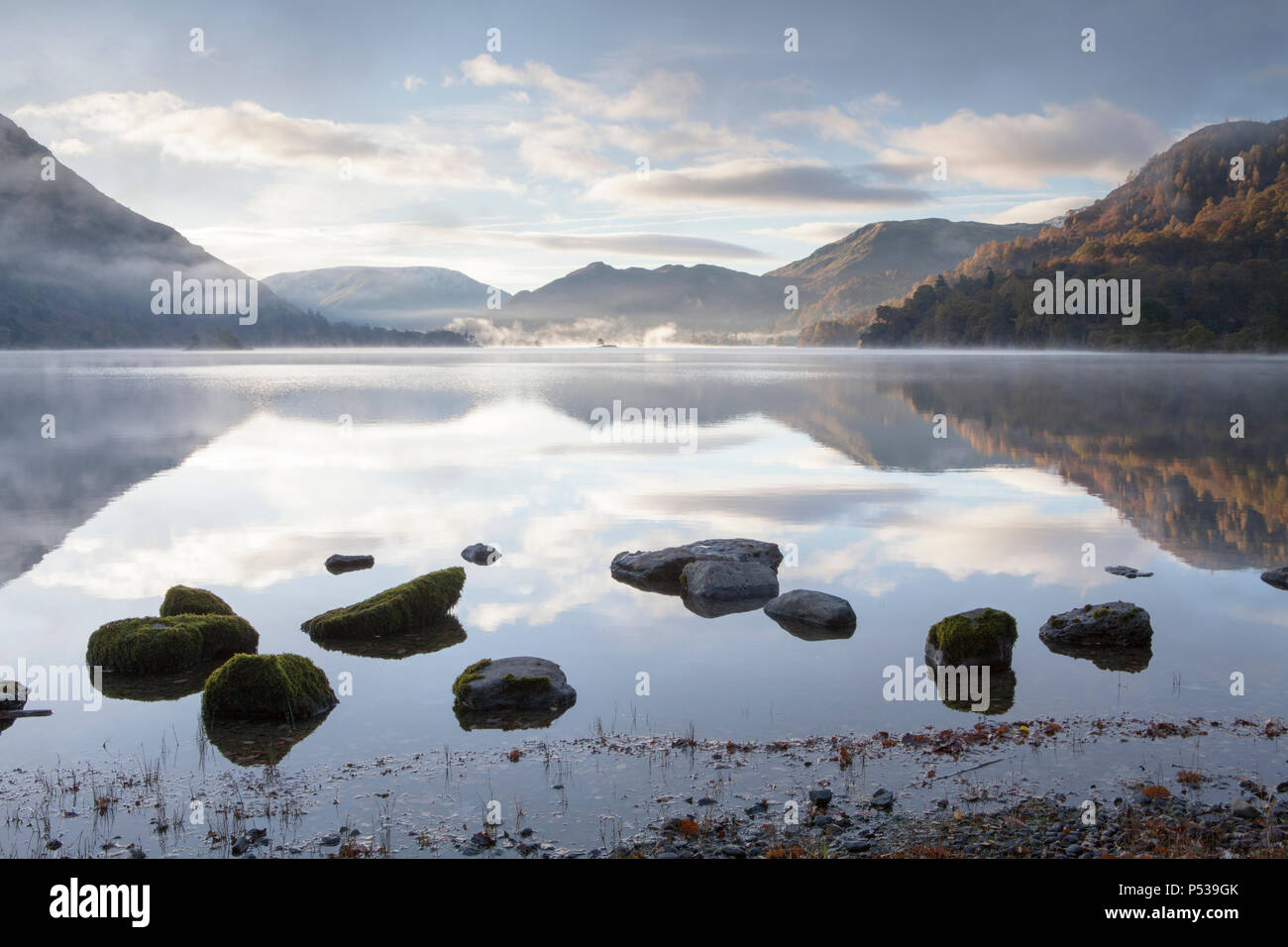 A calm still morning on the shore of Ullswater in the Lake District National Park Stock Photo