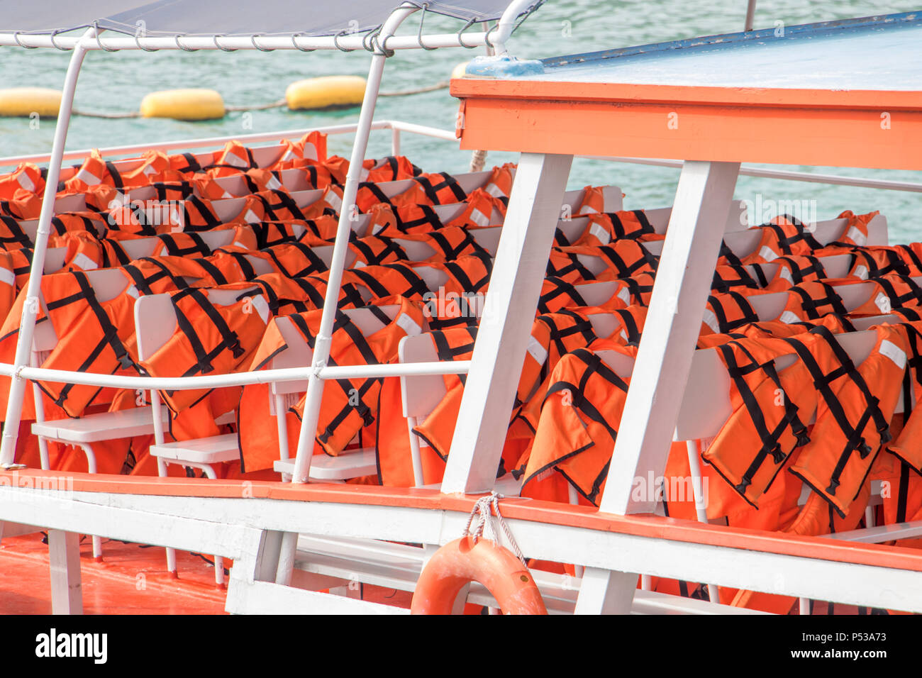 Life jackets on the deck of a cruise ship. Life vest ready for ferry  passengers Stock Photo - Alamy