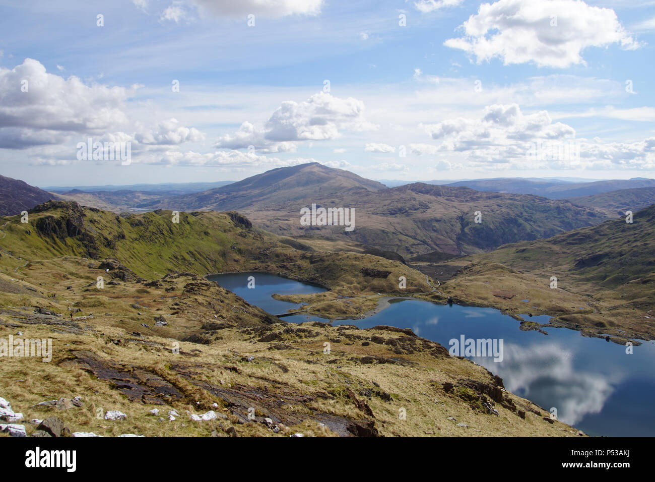 A view in Snowdonia, North Wales, looking across the mountains and lakes from the Pyg Track going up Snowdon. Below is part of the Miners Track. Stock Photo