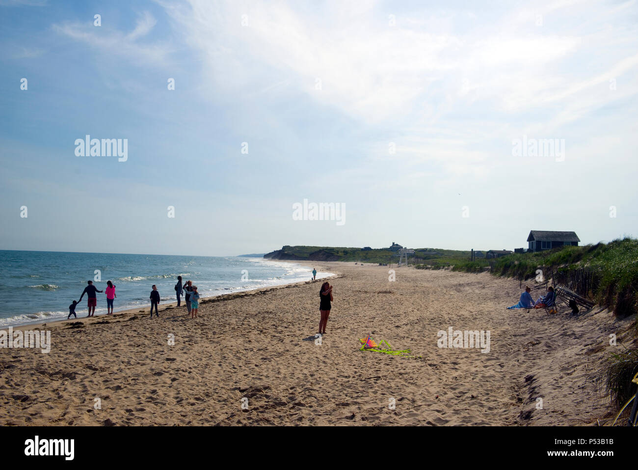 MONTAUK, NEW YORK-JUNE 8: Beachgoers and girl seen flying kite on Ditch Plains Beach, Montauk, The Hamptons, New York on June 8, 2018. Stock Photo
