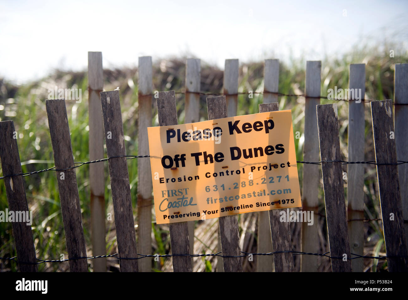 MONTAUK, NEW YORK-JUNE 8: First Coastal erosion control project sign to keep off dunes is seen on beach in Montauk, New York, The Hamptons on June 8,  Stock Photo