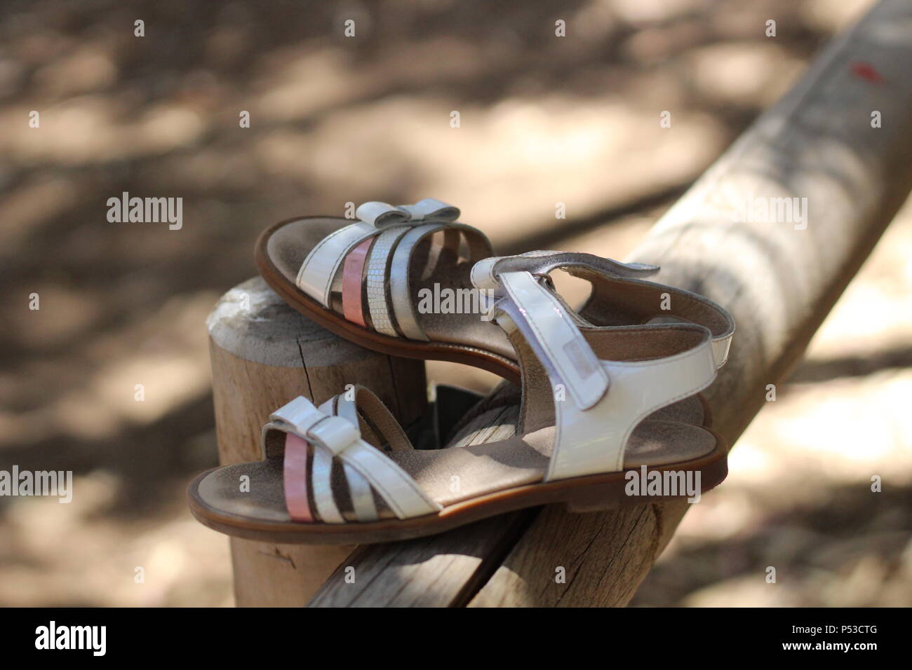 Still life - The Vanishing - A pair of white and pink sandals left behind on a fence post in a national park, La Mata, Spain. Summer 2018. Stock Photo